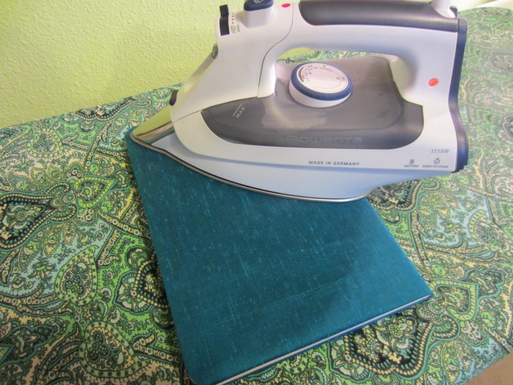 Pressing well to bond the fabric to the book