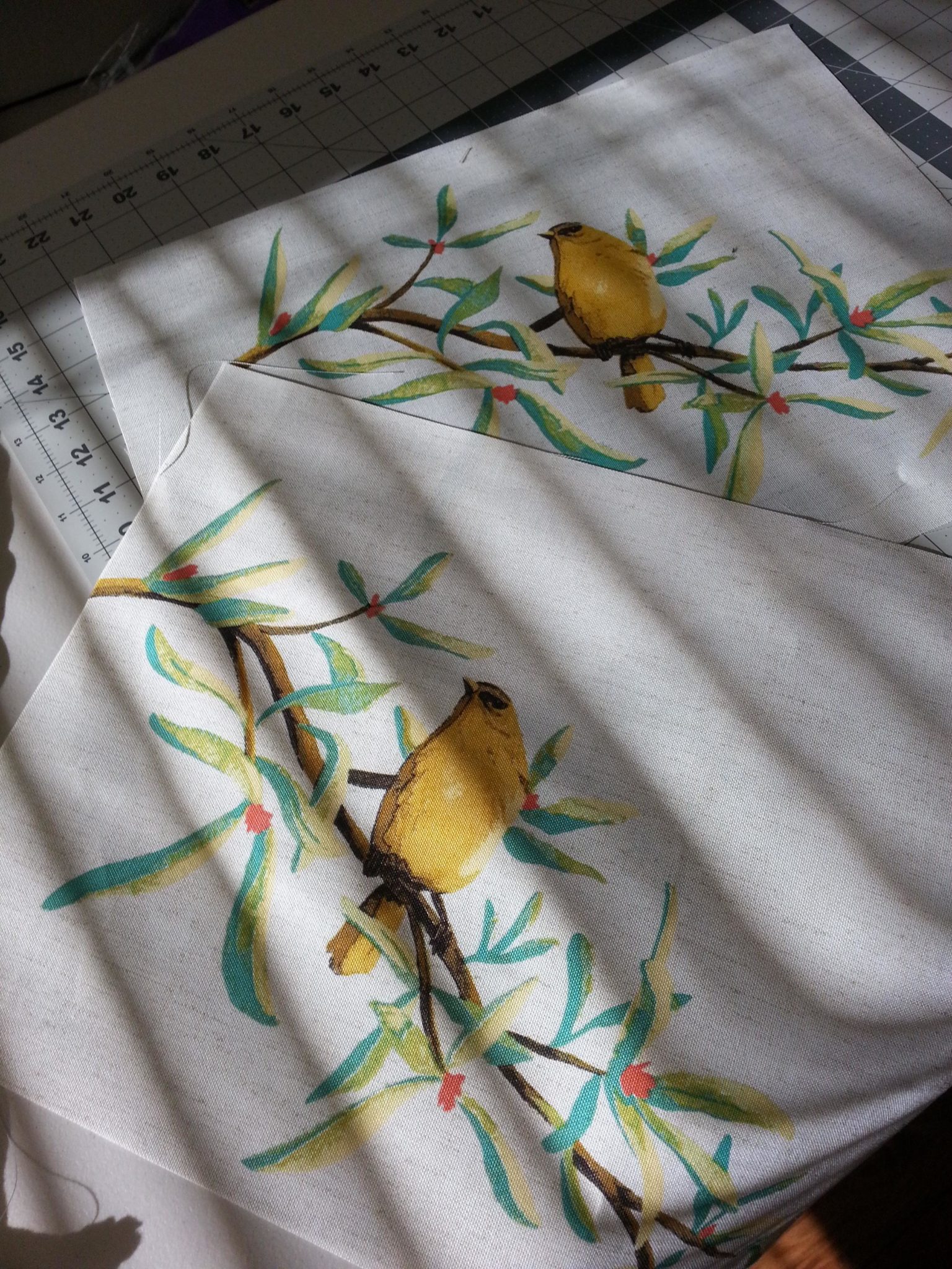 Fussy cutting the fabric to center the birds on the fronts of the pillows