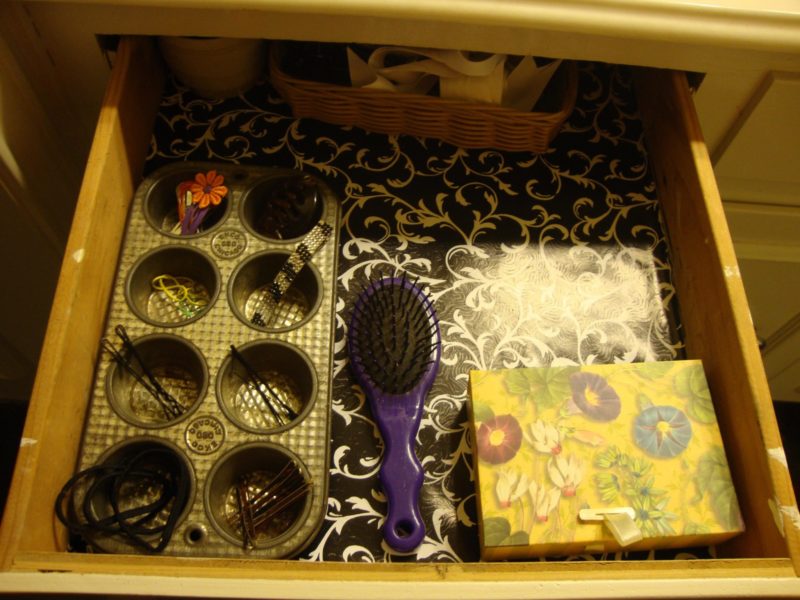 Hair accessories organized in an old muffin tin.