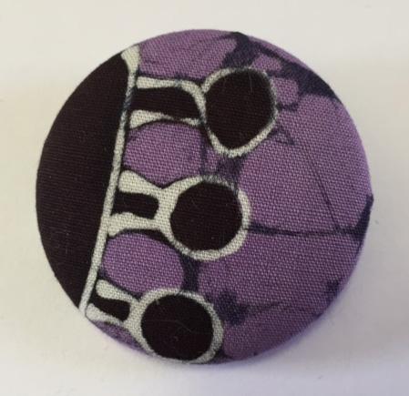 Purple and black covered button