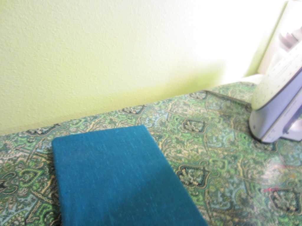 Bonding the fabric to the book with the iron