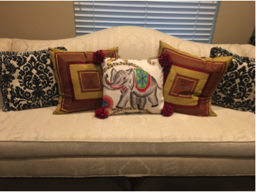 Loveseat with lots of decorator pillows