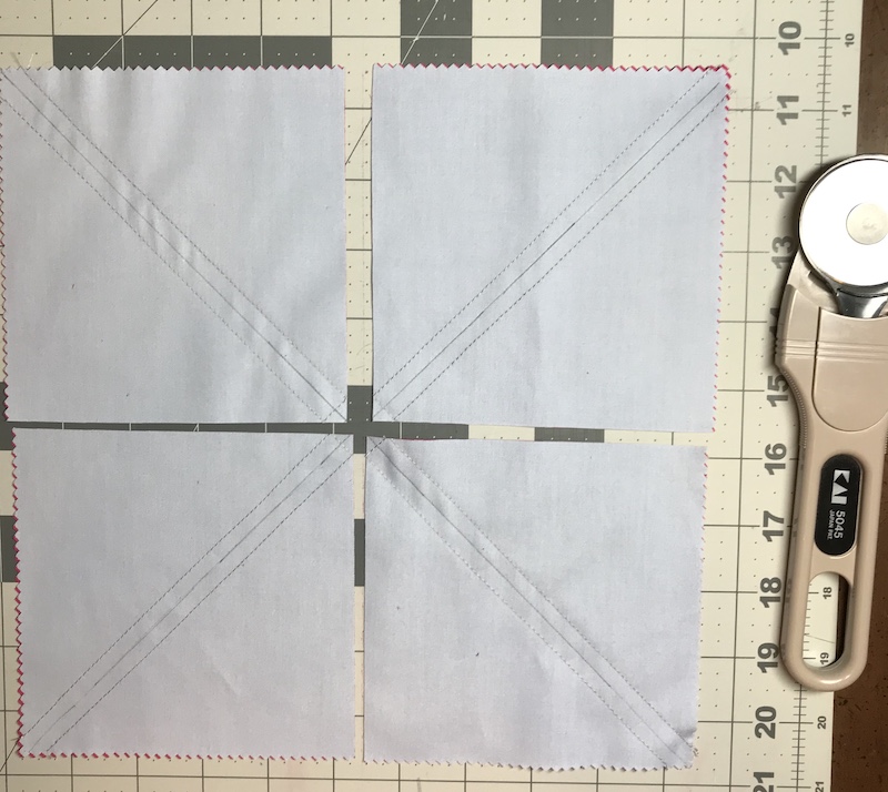 Half square triangles eight at a time from a layer cake ready for the final cuts