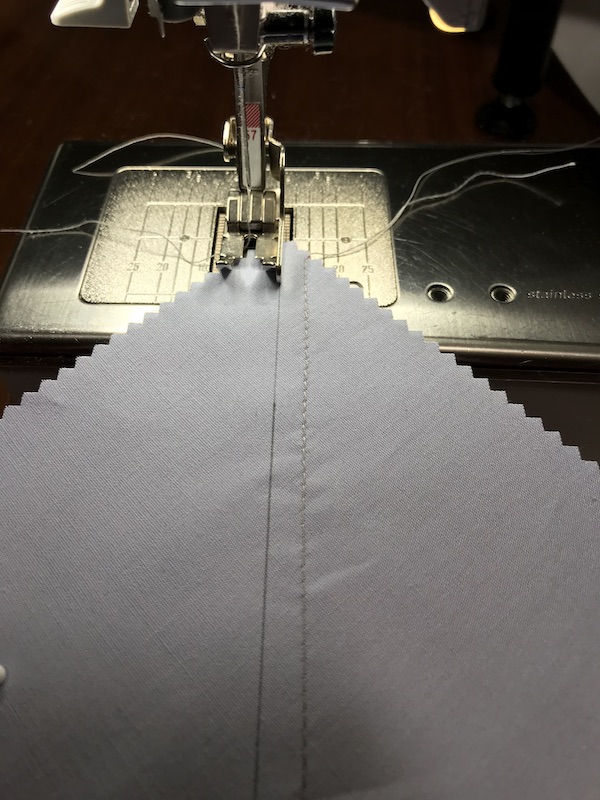 Sewing the second seam to make eight half square triangles at a time from a layer cake