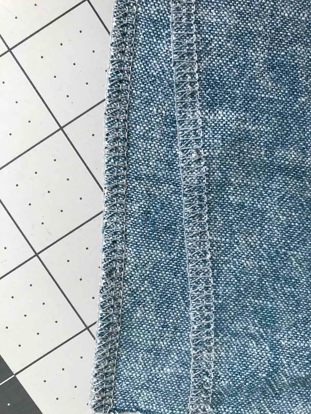 Edges of the fabric are finished to then begin the steps for the welt seam