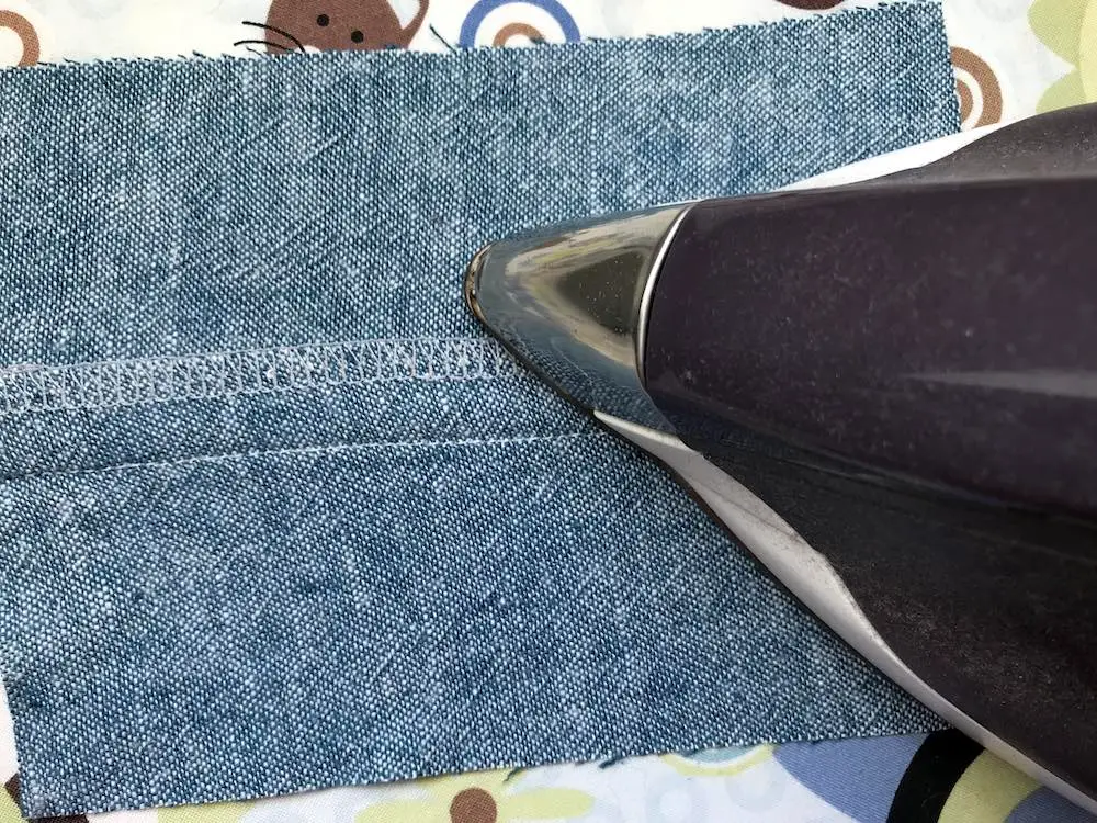 After pressing the seam open, then press both seam allowances to one side.