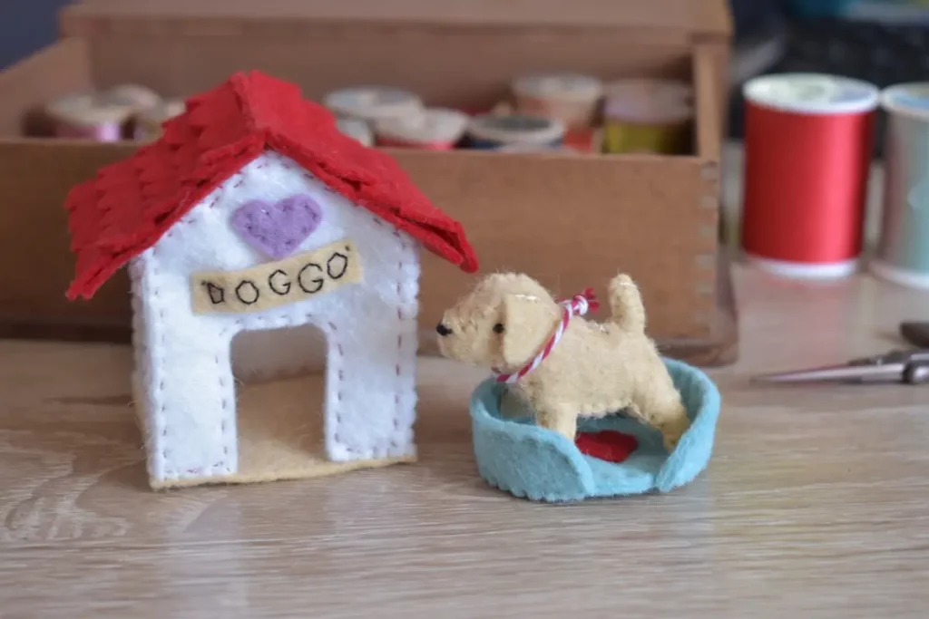 Tiny felt dog and dog house