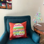 Easter pillow cover on turquoise chair view 3