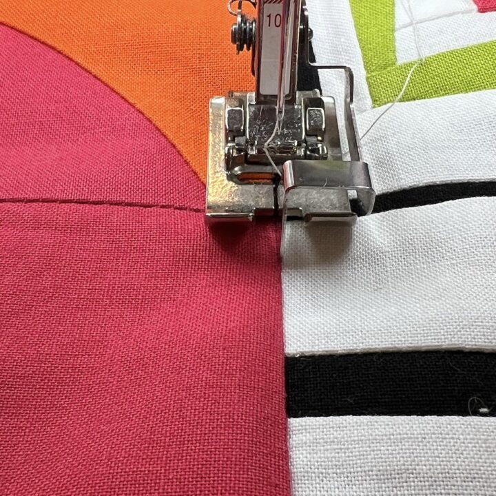 Stitch in the ditch showing how the presser foot nestles in the seam