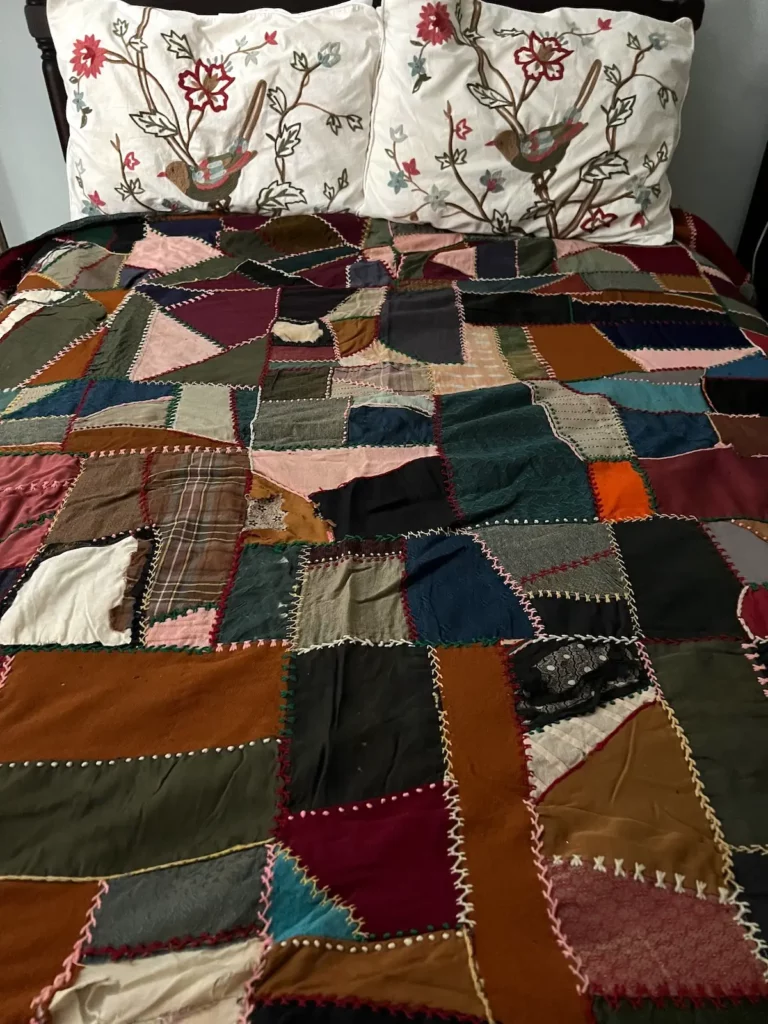 Vintage crazy quilt on a bed