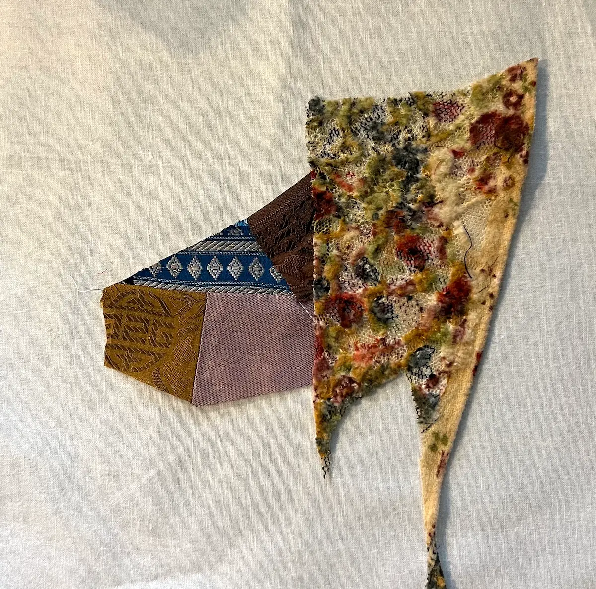 Auditioning the lace as the fifth piece for the crazy quilt block