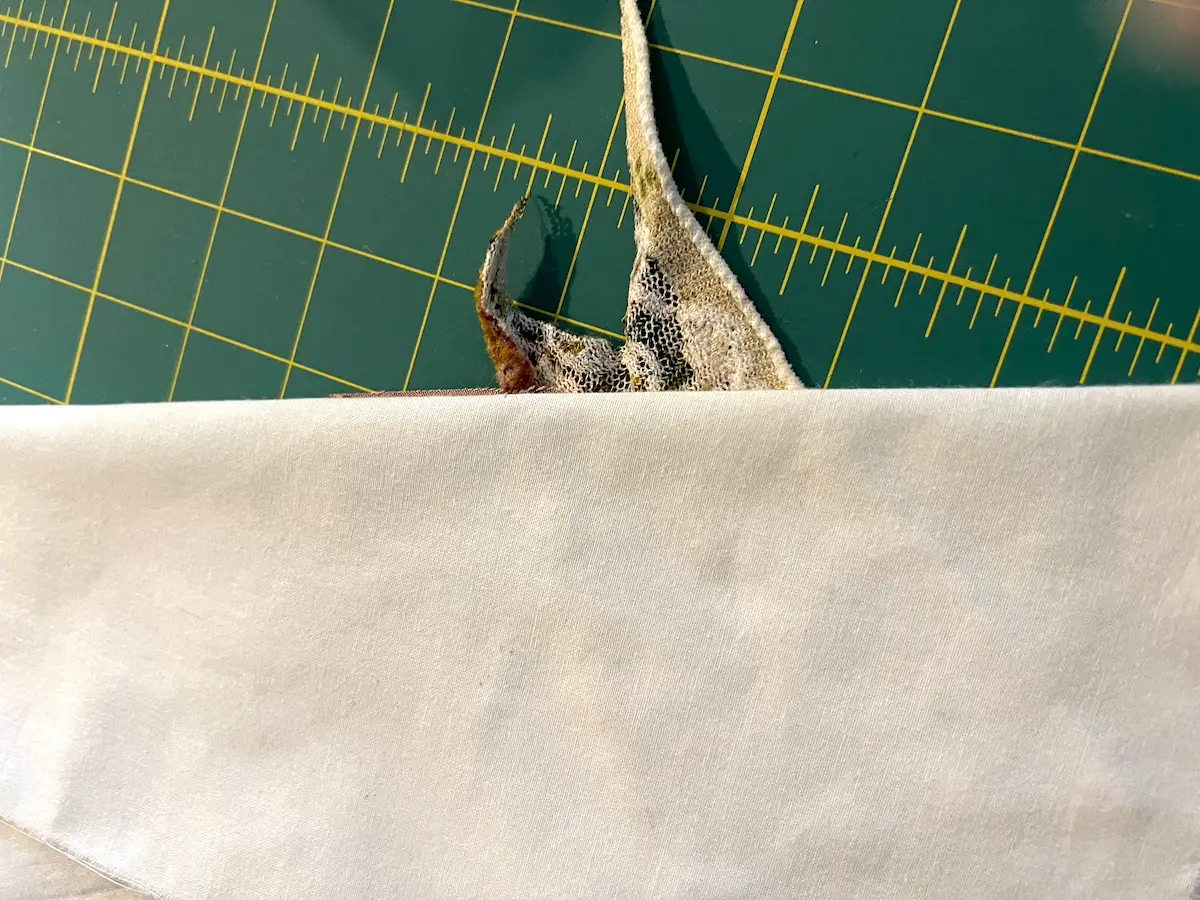 Fold back the foundation fabric on the next raw edge line and trim the fabric