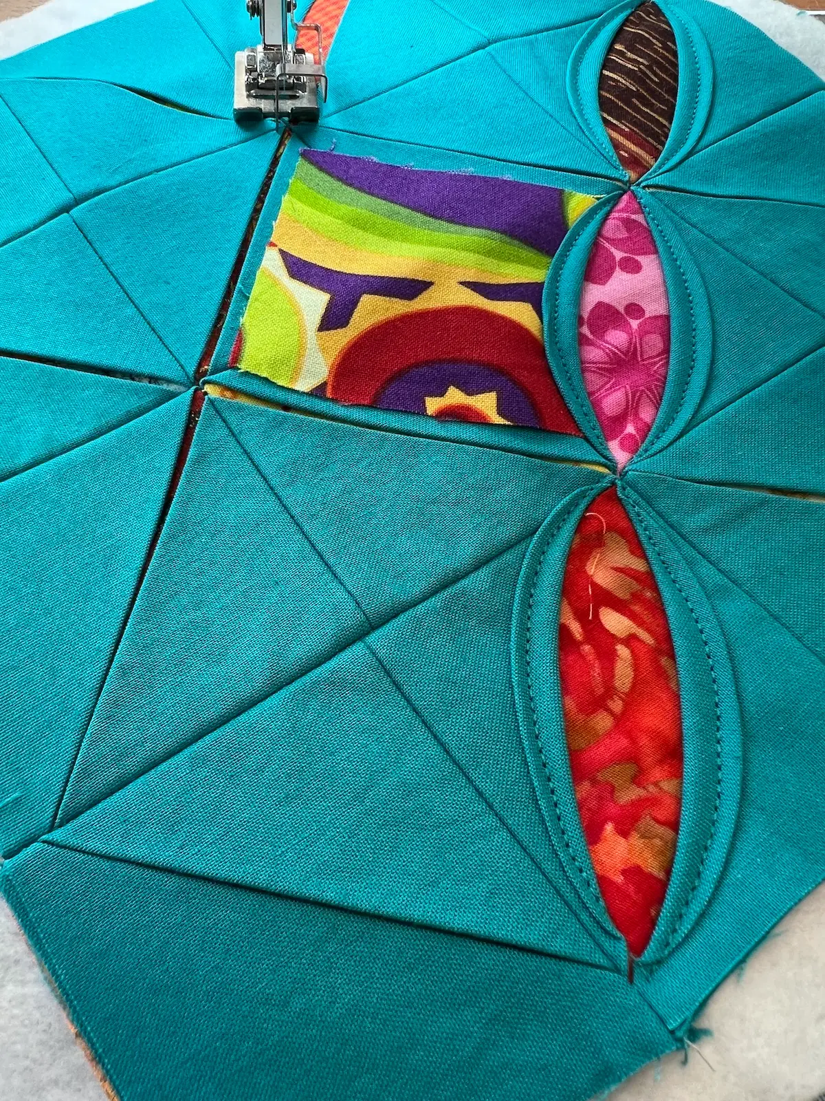 Easy Cathedral window quilt showing both sides of one diagonal all stitched and beginning another long diagonal