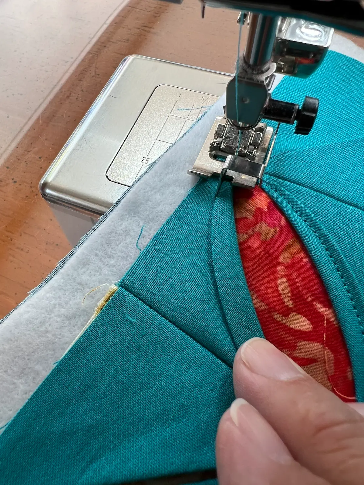 Easy Cathedral window quilt at a corner, needle down to pivot the piece and then sew back the other side