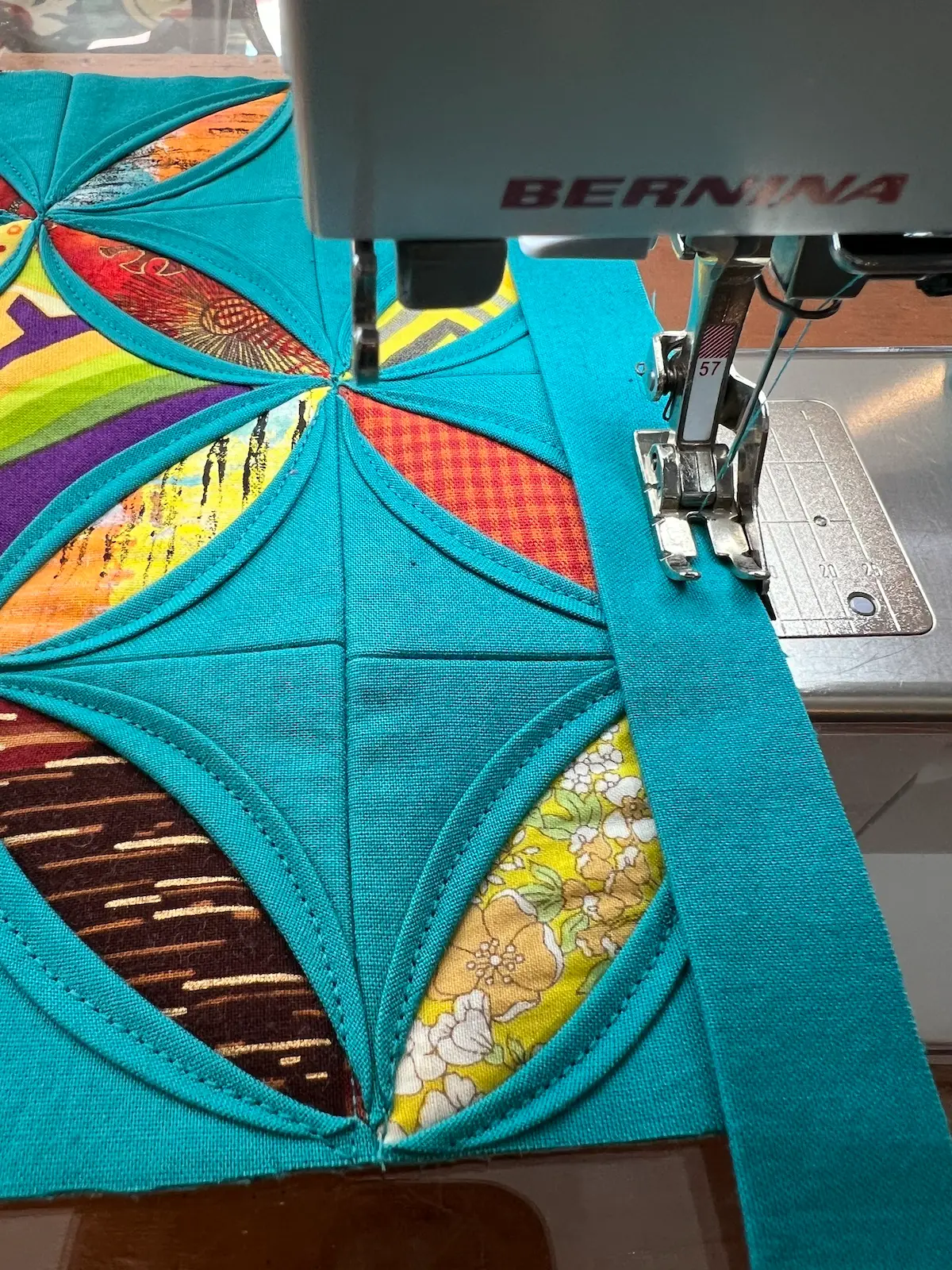 Sewing the binding to the easy cathedral window quilt sampler