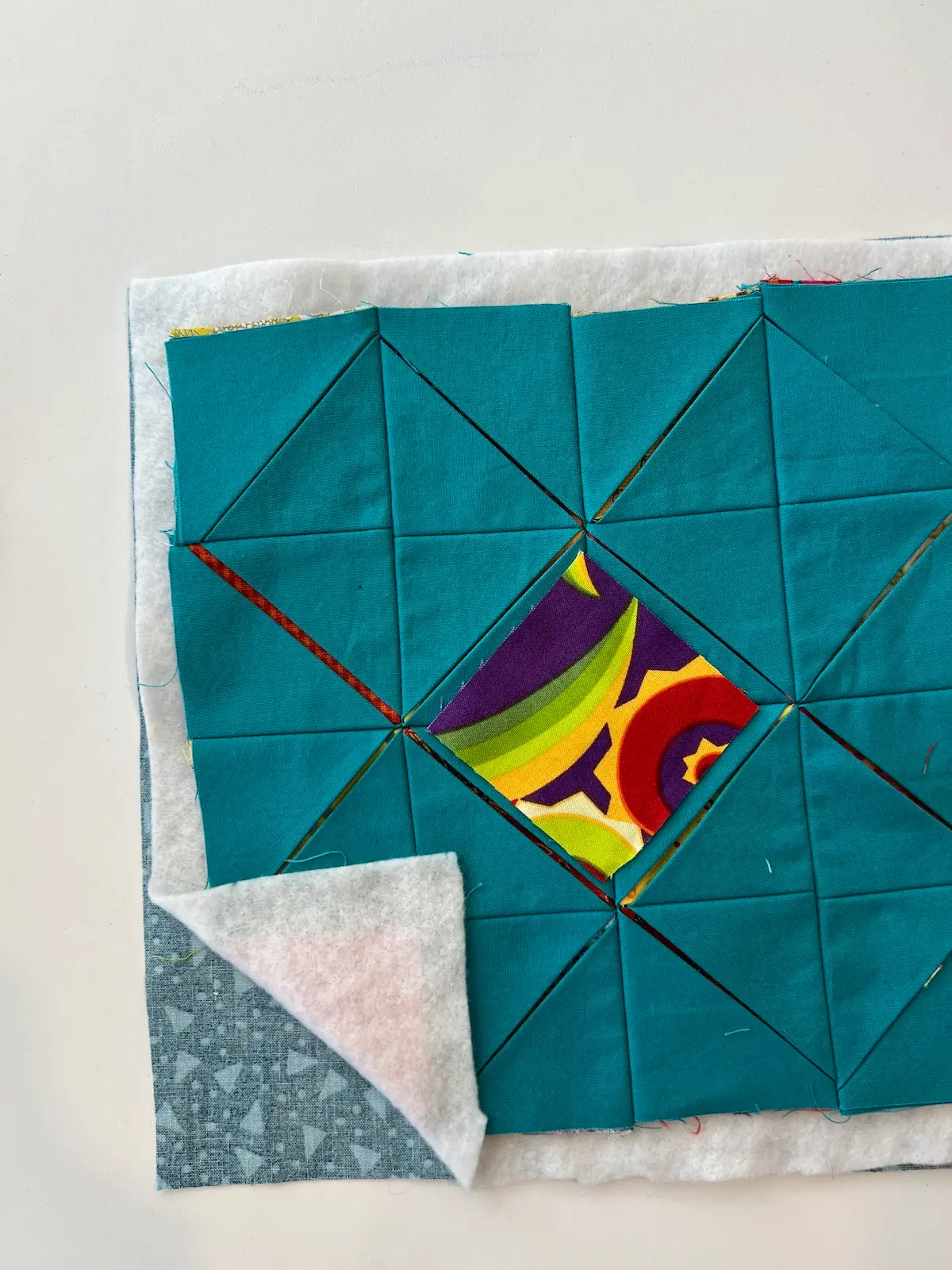 Easy Cathedral window quilt showing the layers put together and the center window placed