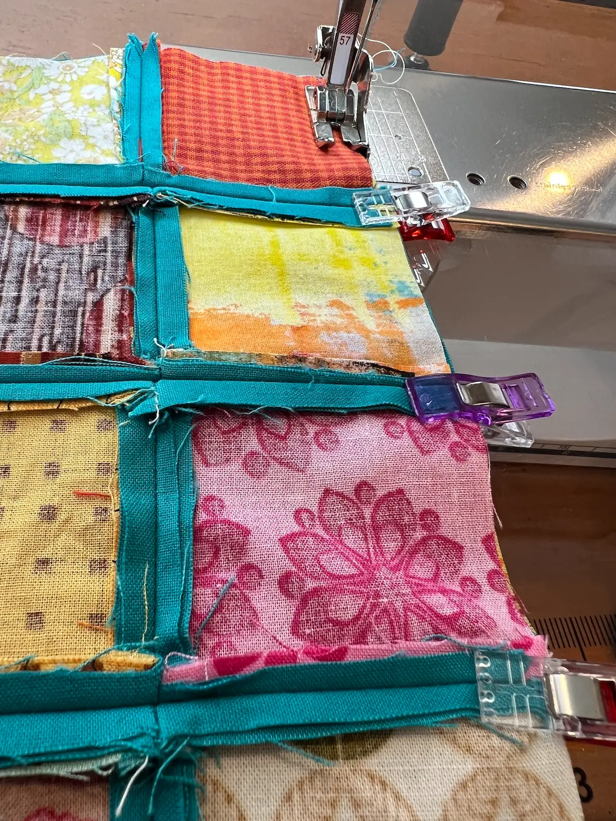 Easy Cathedral window quilt sew the rows together. Use clips to hold the seams in place