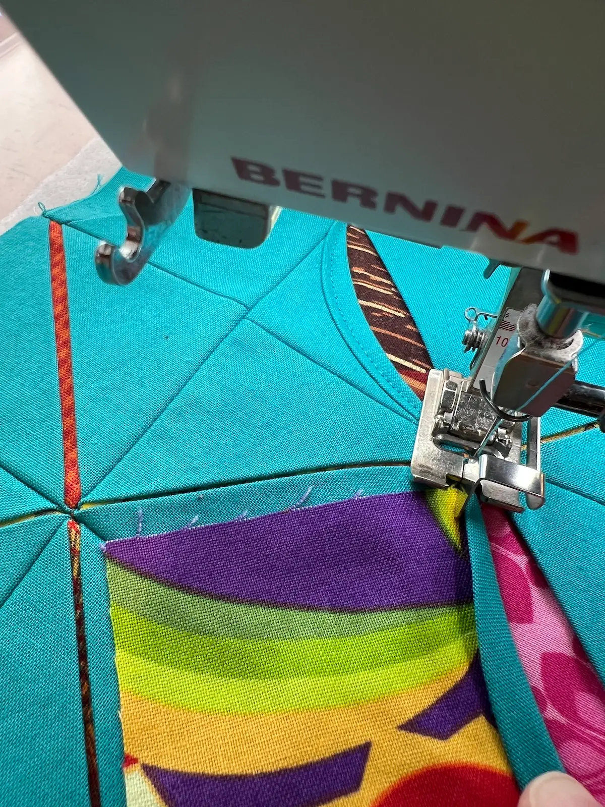 Easy Cathedral window quilt needle down between blocks to pivot the fabric