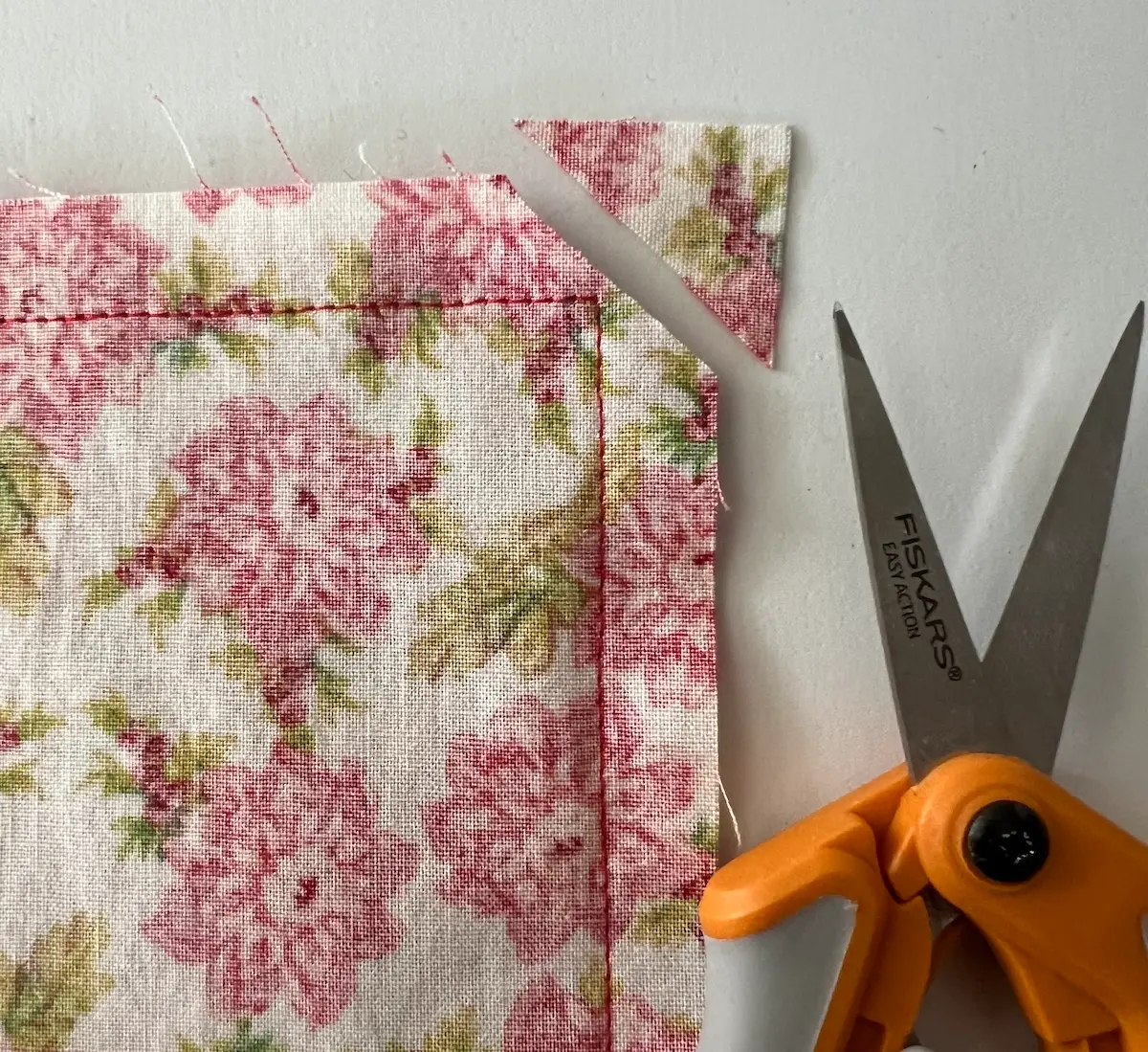 Clip the corners of the napkin so that there is less bulk when turning right side out
