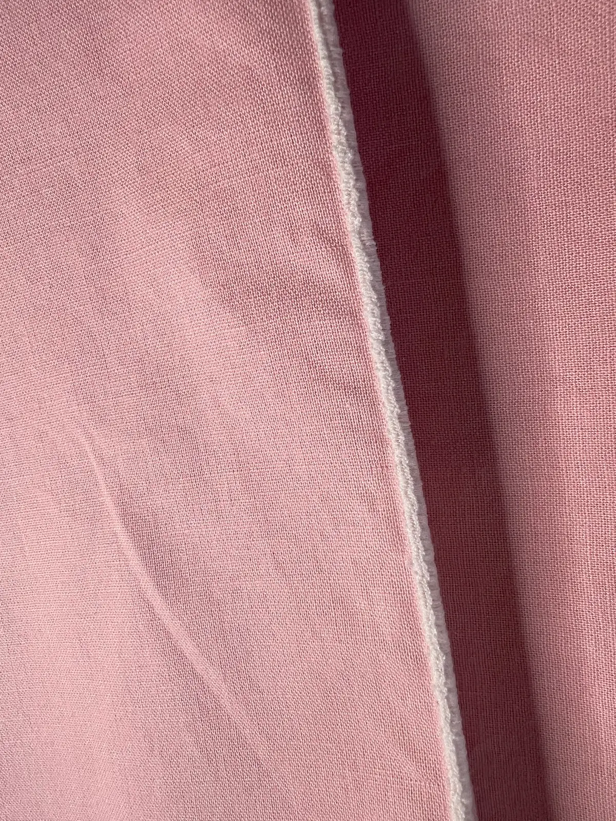Finished closeup of a serged rolled hem on a napkin