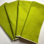 Finished green serged rolled hem napkins