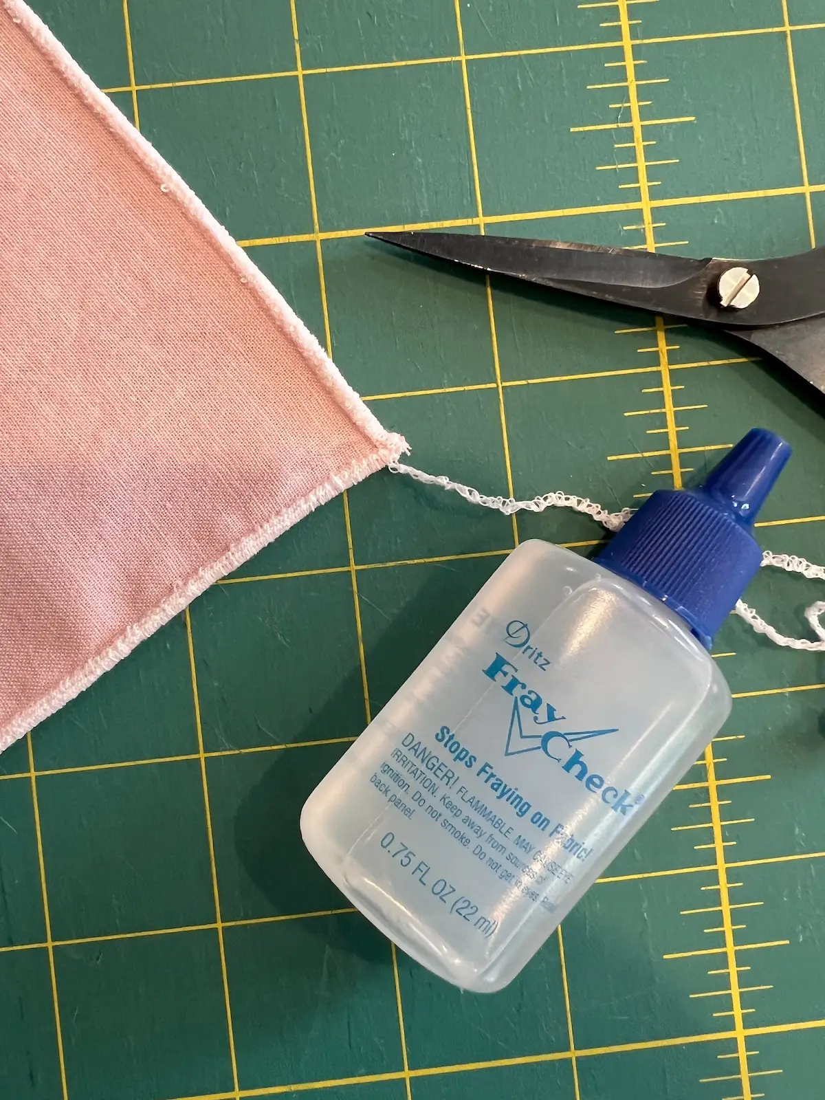 Use a dot of fray check when cutting the threads from the corners for the serged rolled hem napkins