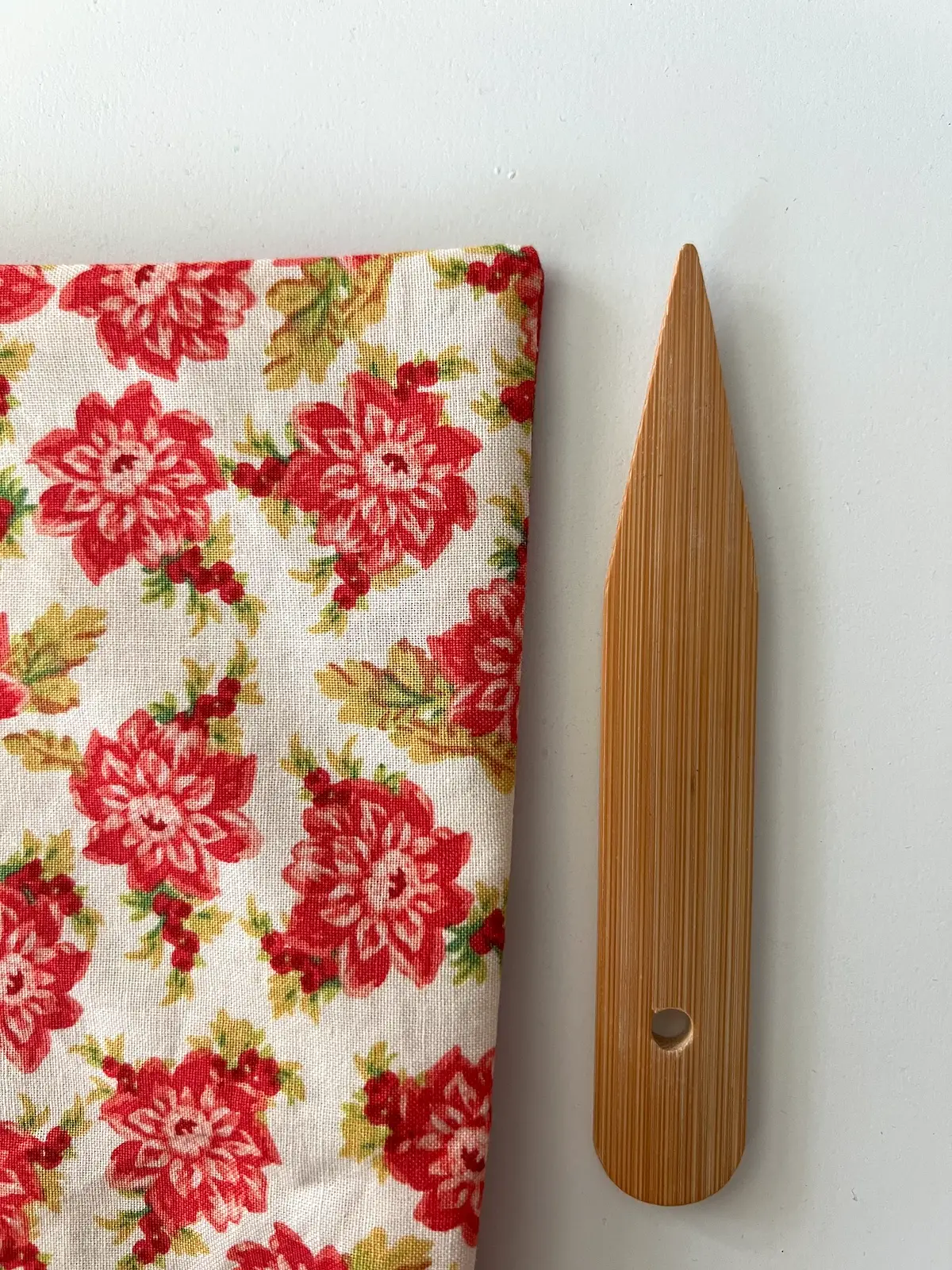 Gently poke out the corner of the reversible napkin with a corner turner
