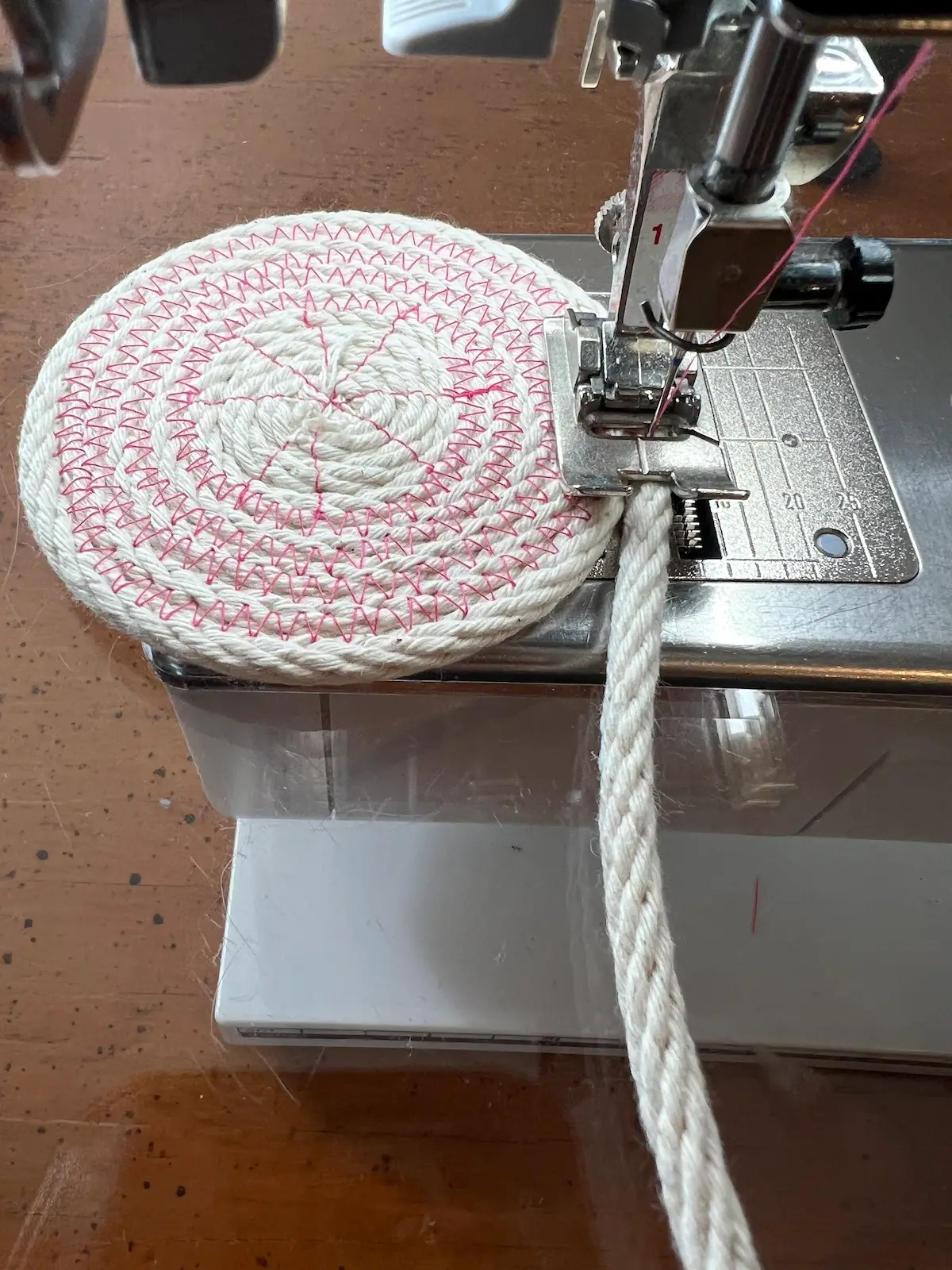 Bottom of the pink rope basket is beginning to take shape