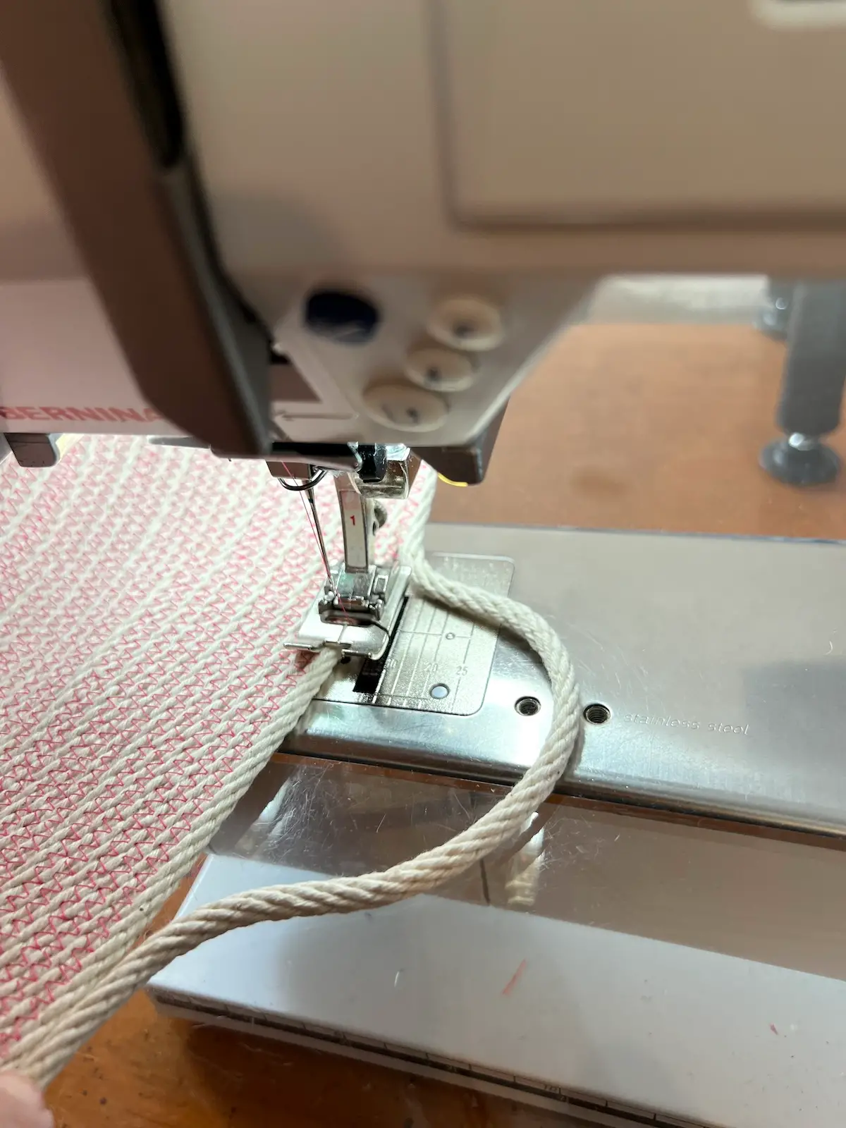 Leave an opening for a loop to make a handle on the pink rope basket