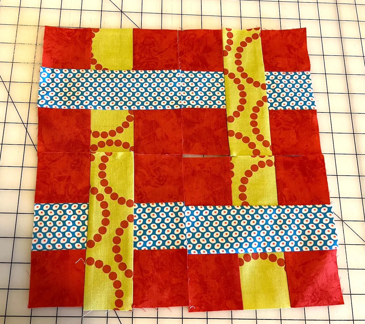 Here are four blocks sewn together and laid out to show the weave in the 7 patch weave quilt block