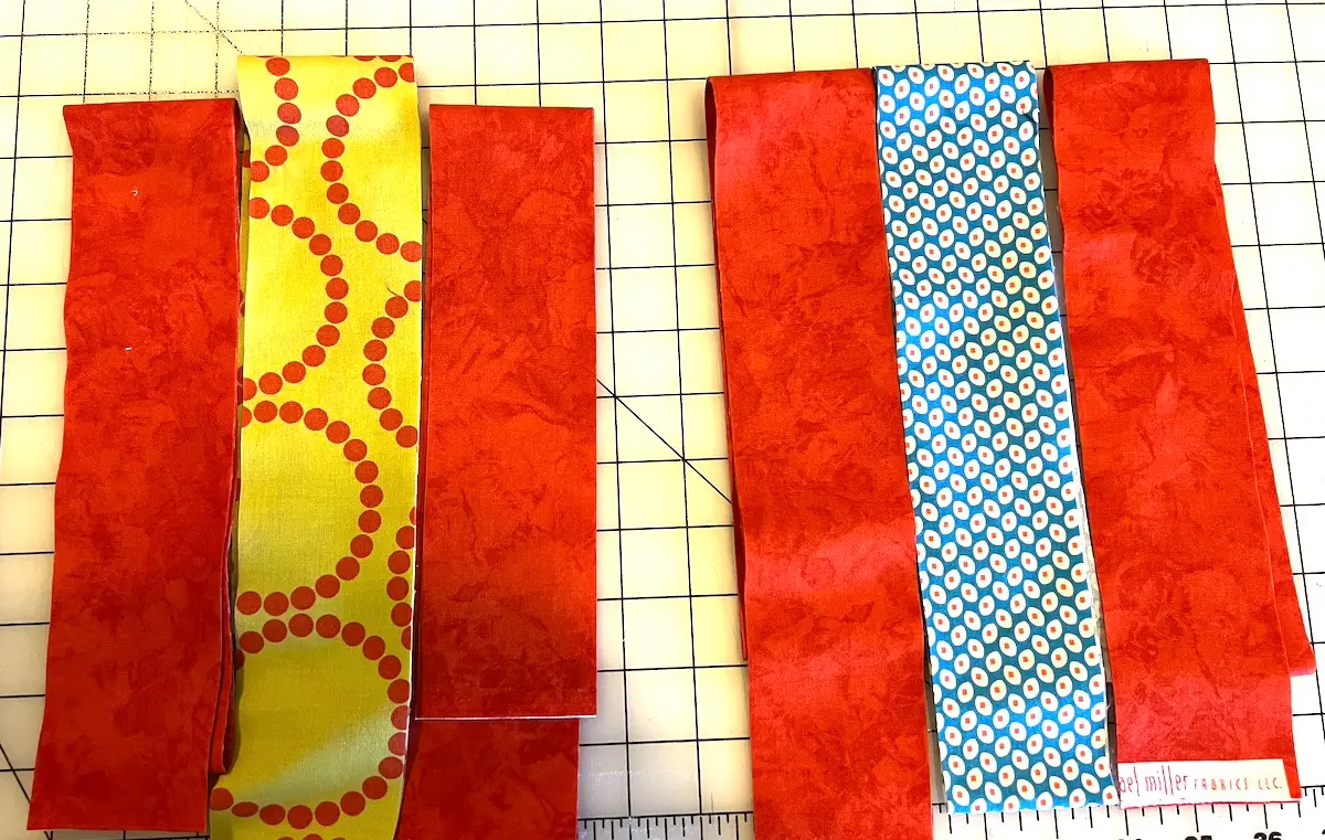 Laying out the strips for the 7 patch weave quilt block