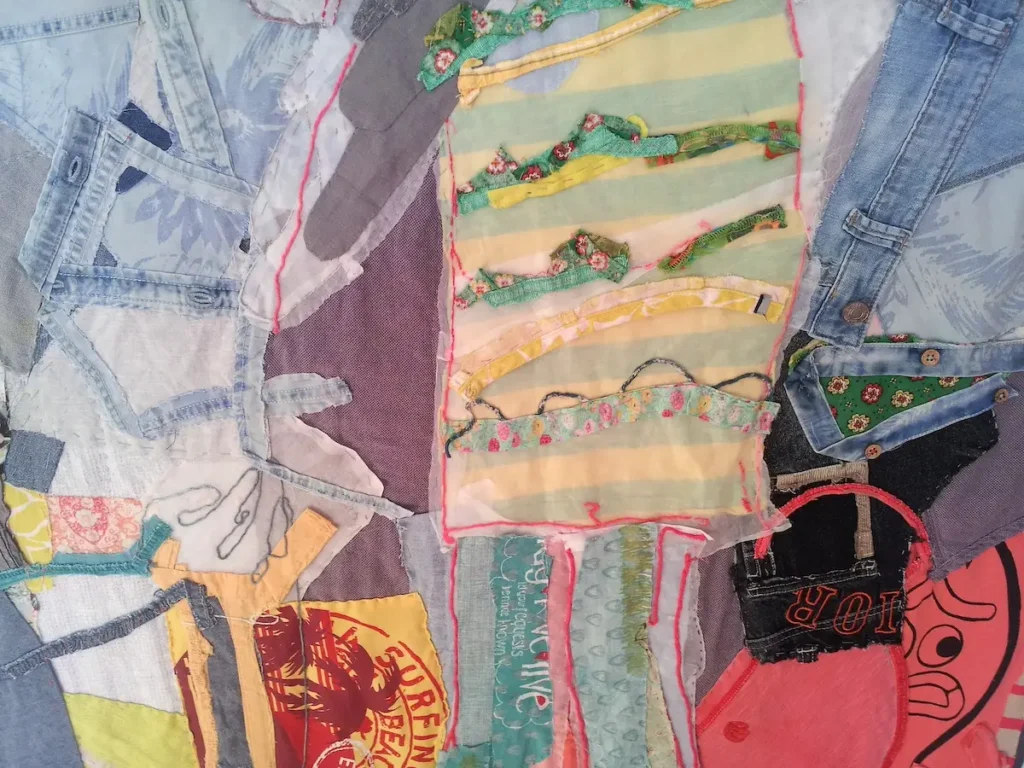 Detail of Saint Jude by the Dumpster fiber art by Anne Smith