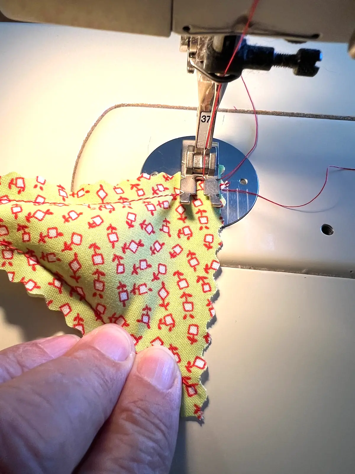 Sew the bottom shut on the christmas tree ornament