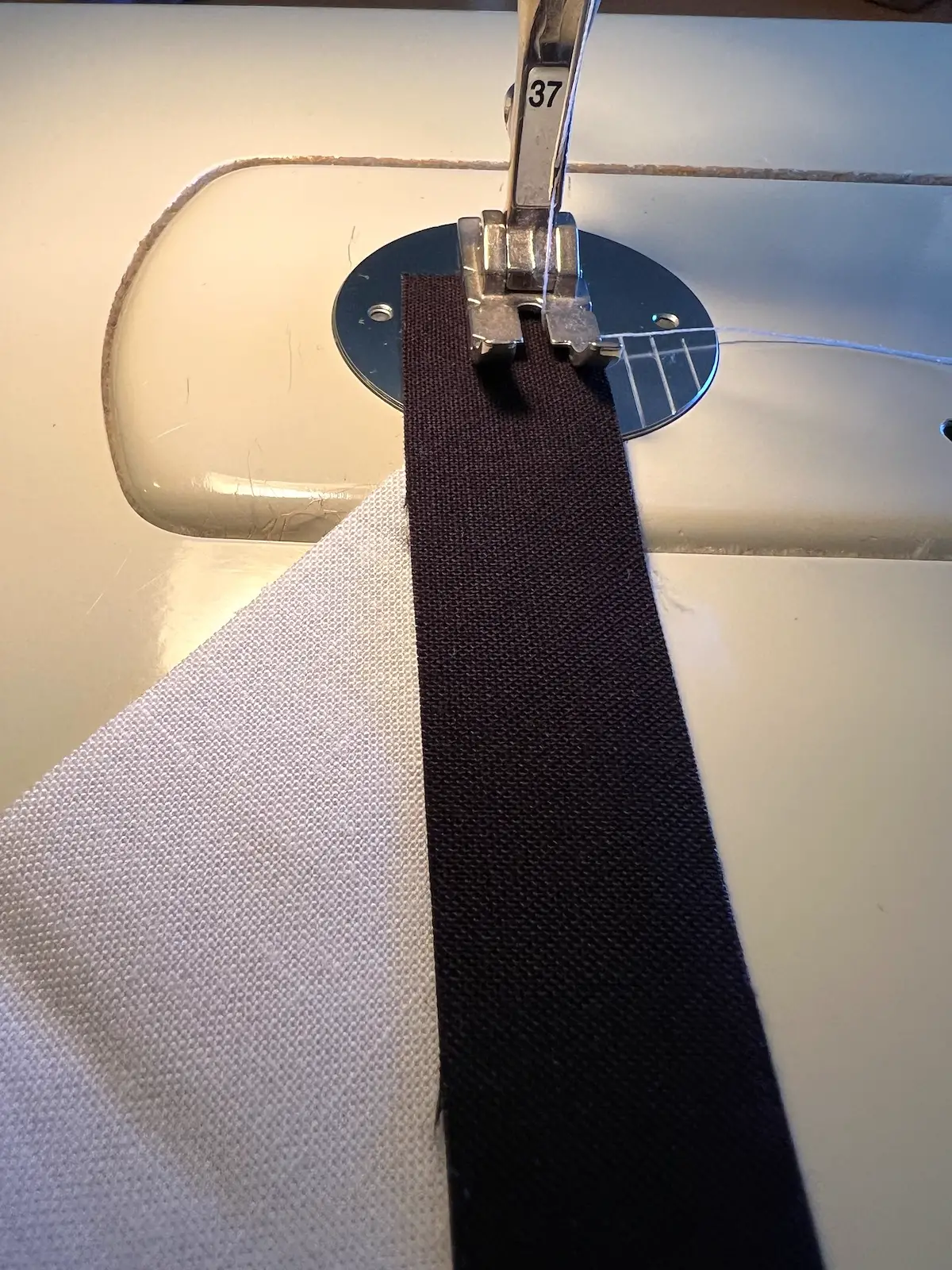 Sew the strip to one of the cut pieces of fabric with a quarter inch seam allowance