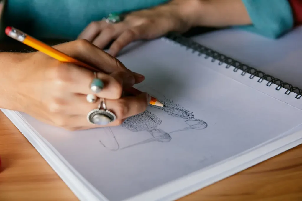 Isa Guadalupe Medina drawing in her sketchbook