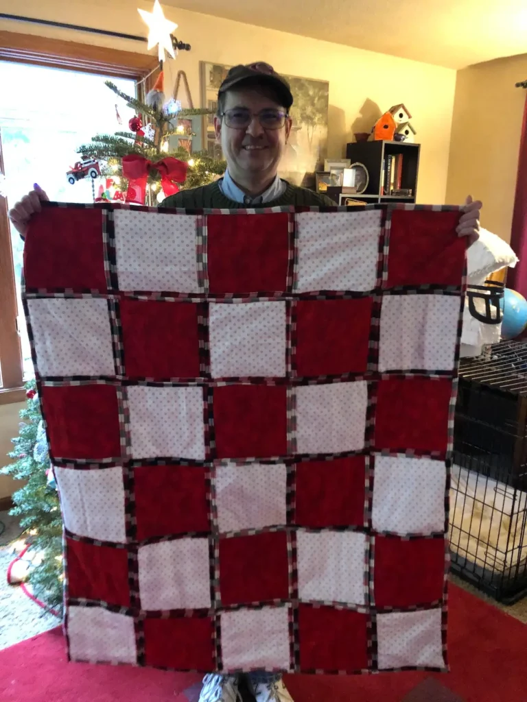 Red and white quilt made by Monique Arnold