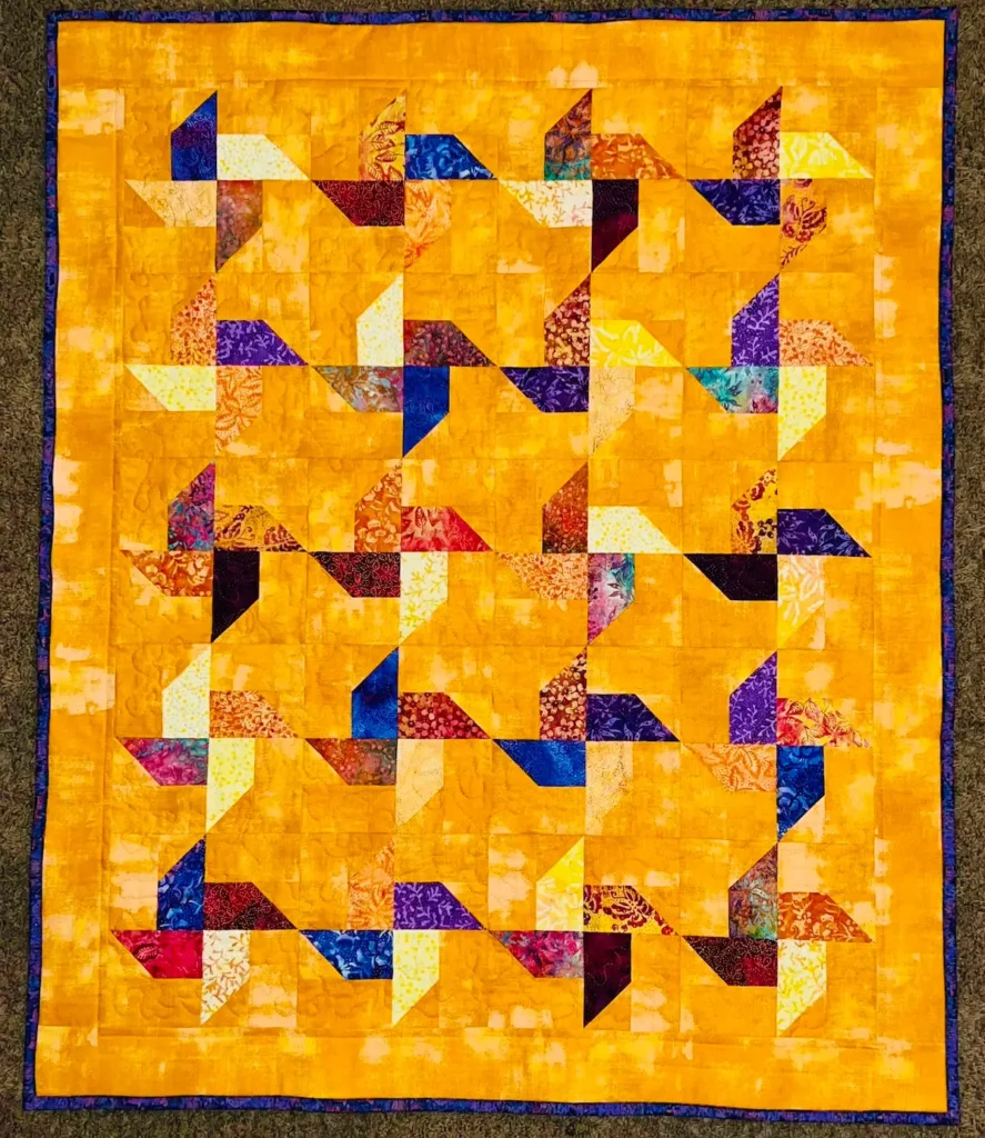 Yellow pinwheel quilt by Monique Arnold