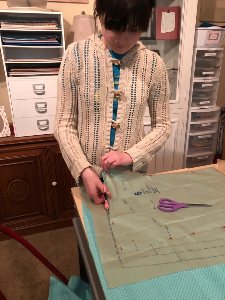 Young girl cutting out a pattern with Monique Arnold