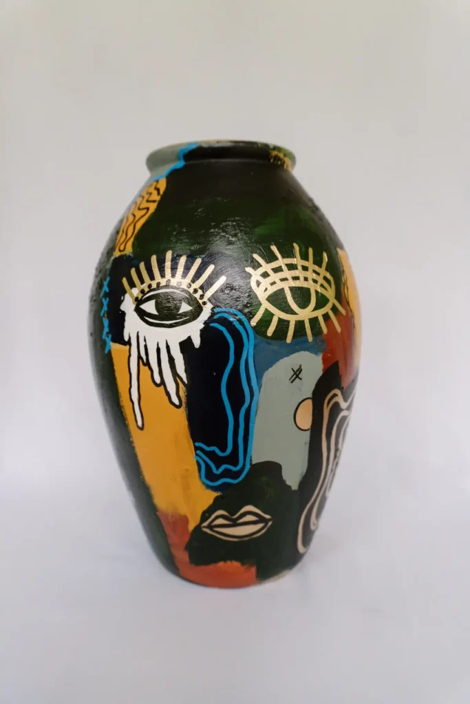 Vase with face painting by Shira Coward Kelly