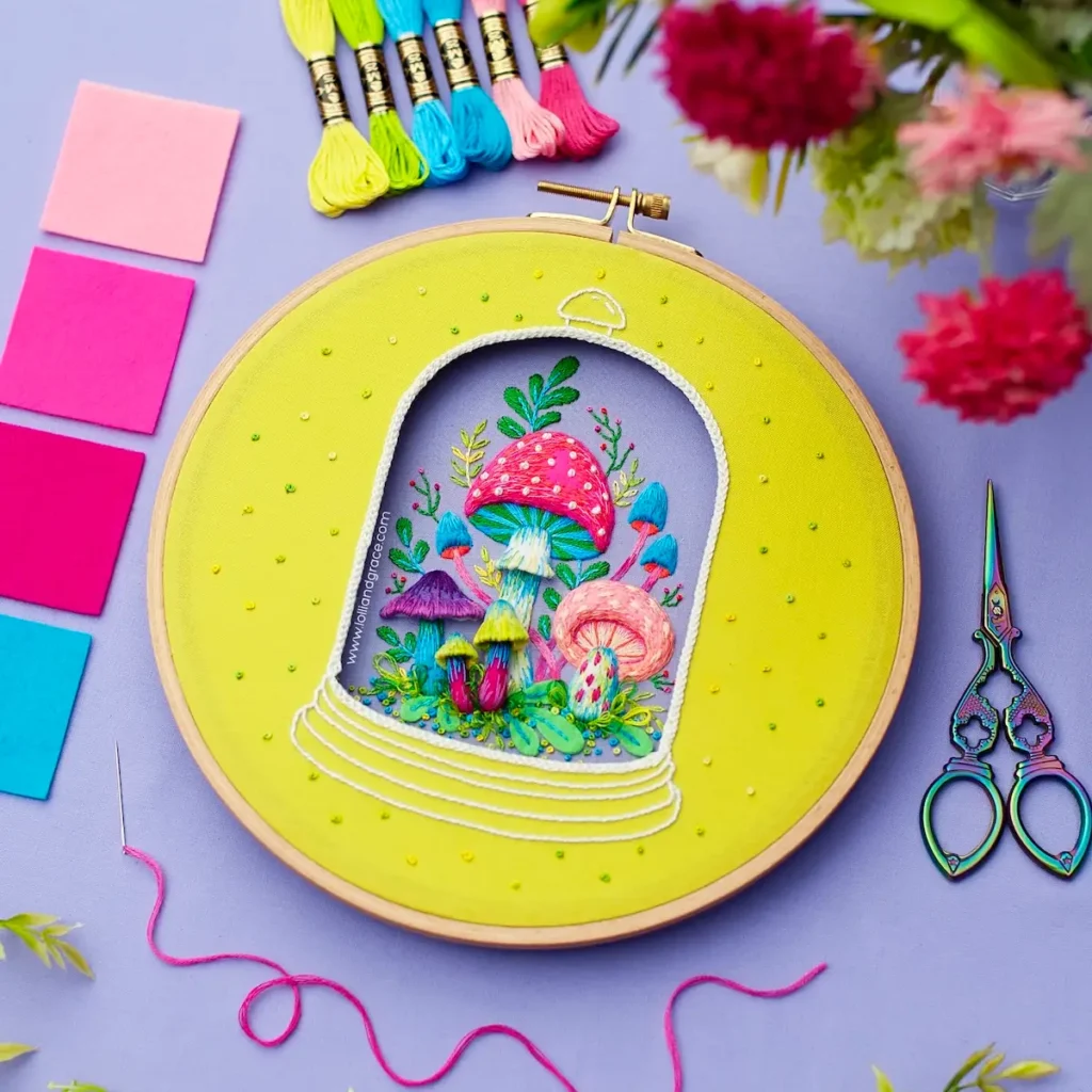 Mushrooms in a shadow box stitched by Anne Oliver