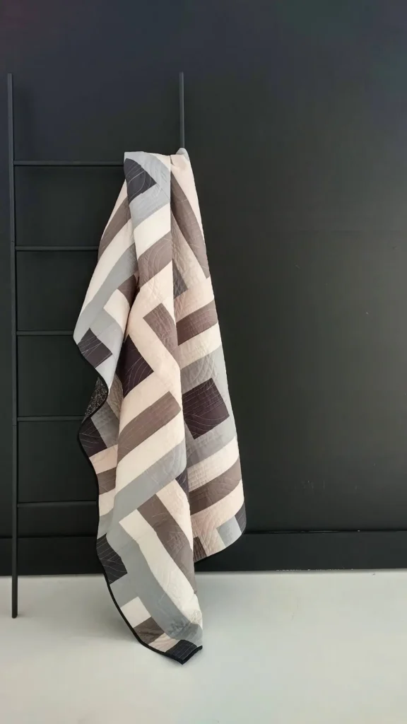 Grey and white quilt by Ashelyn Downs