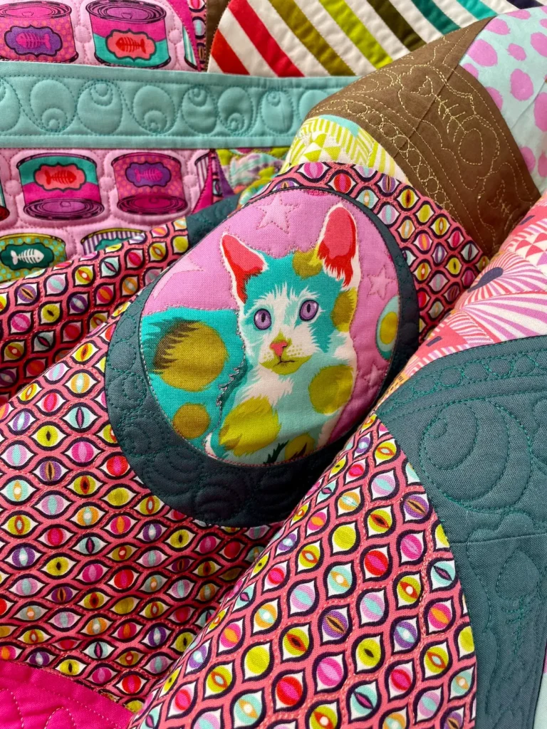 Close up of a kitty in a quilt by Jen Wagner