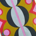 Close up of gold, blue, lavendar, pink and red quilt by Jen Wagner