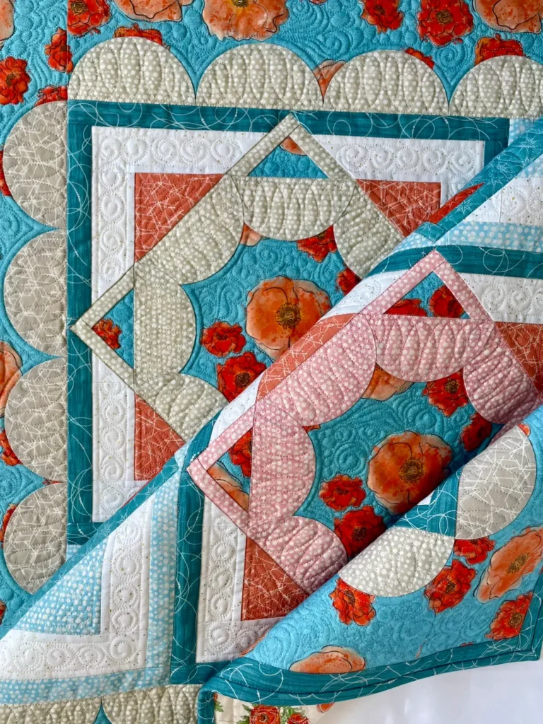 Showing a turquoise and red quilt by Jen Wagner