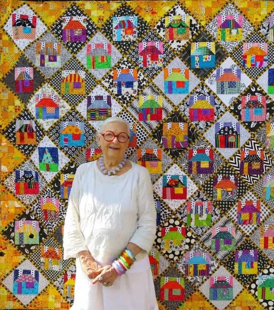 Freddy Moran in front of a house quilt