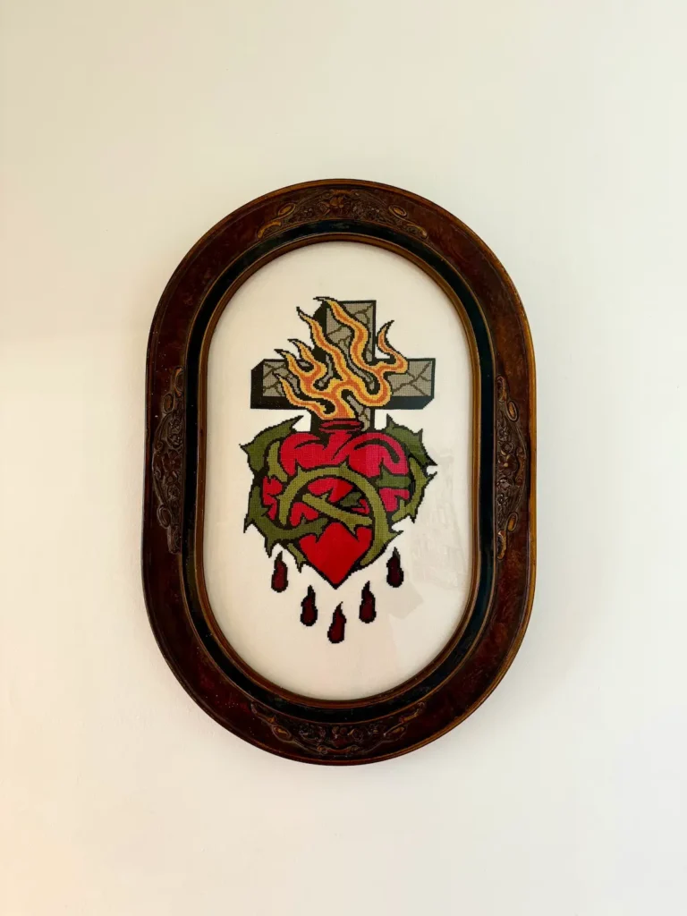 Bleeding heart and cross crossstitch by Maddie Jones