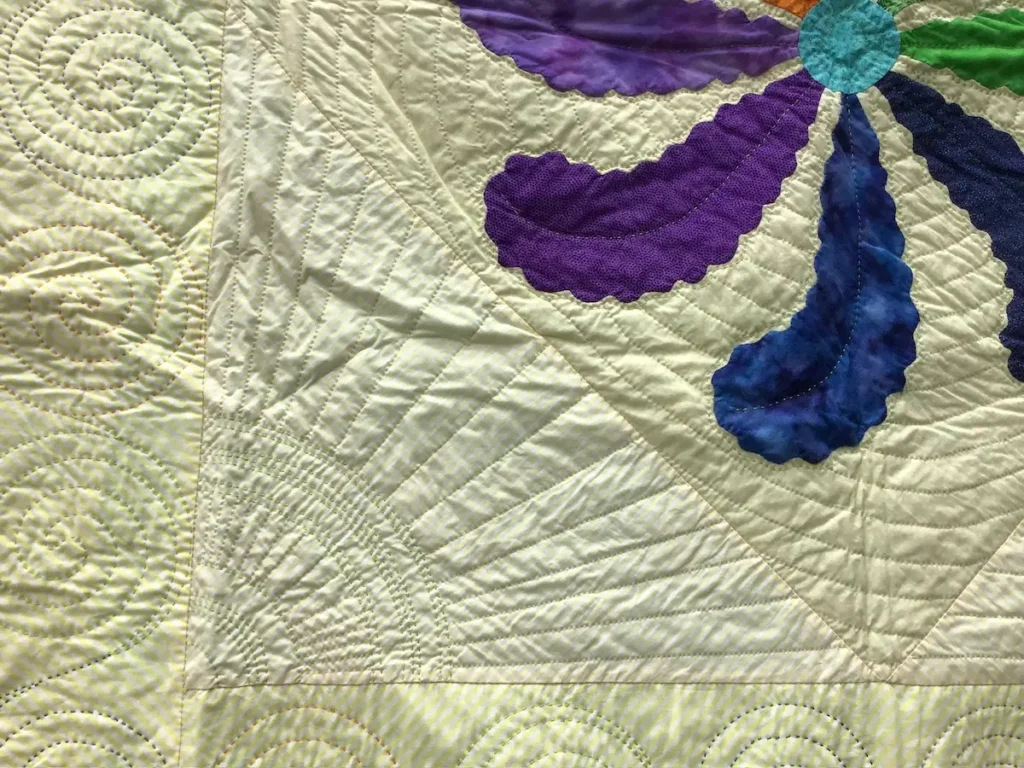 Close up of big stitch and traditional hand quilting designs by Pattie Klimek