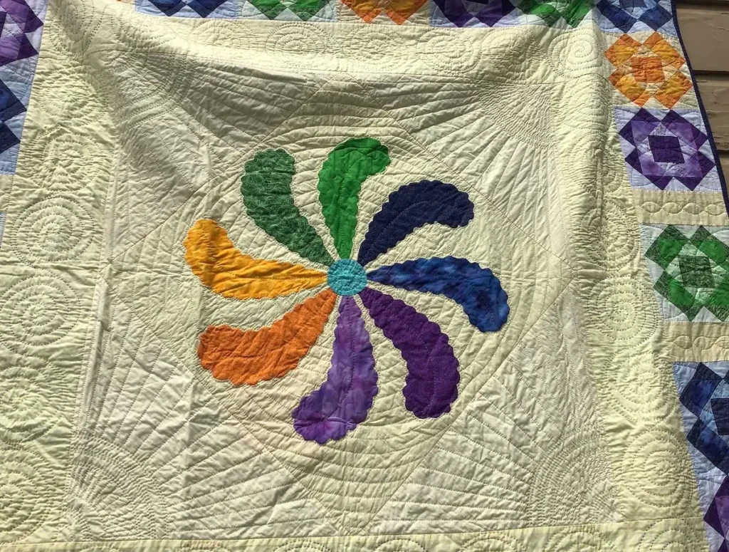 Princess Feather Quilt hanging at the Pacific International Quilt Show that started the push to teach and lecture about the Joy of Handwork by Pattie Klimek