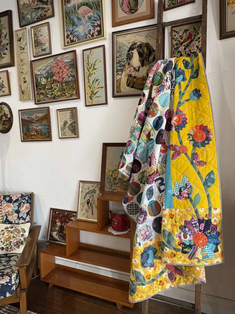 Quilt on a rack in the lounge room by Barbie Mitchell