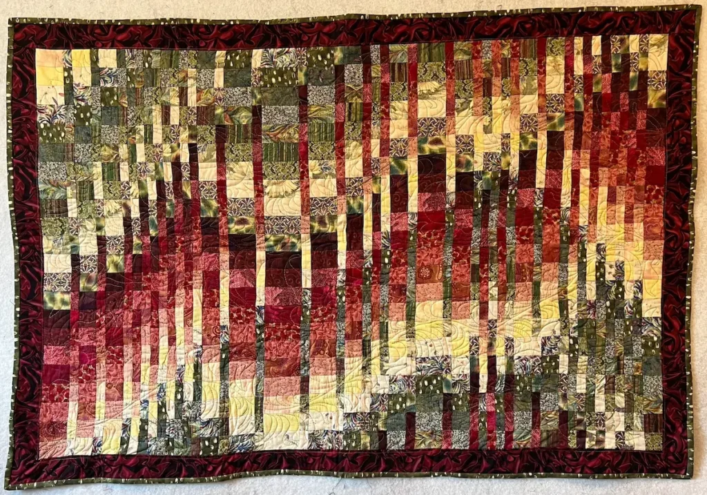Bargello quilt in red green and yellow fabrics
